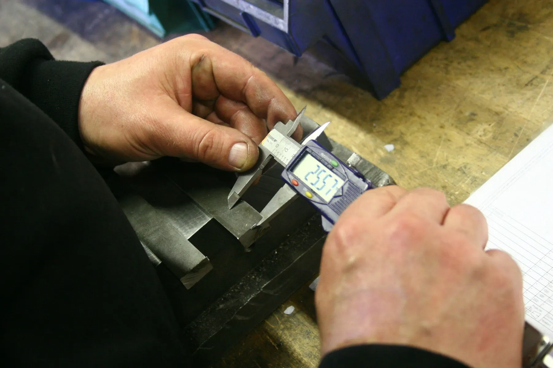 Technician using precision measurement equipment during quality inspection